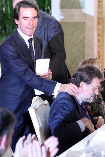 El ex presidente del Gobierno José María Aznar saluda a Mariano Rajoy en un acto celebrado ayer en Madrid.
