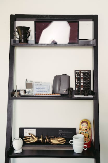 In his office, Norman displays objects related to his career, among them an abacus and a Blackberry.