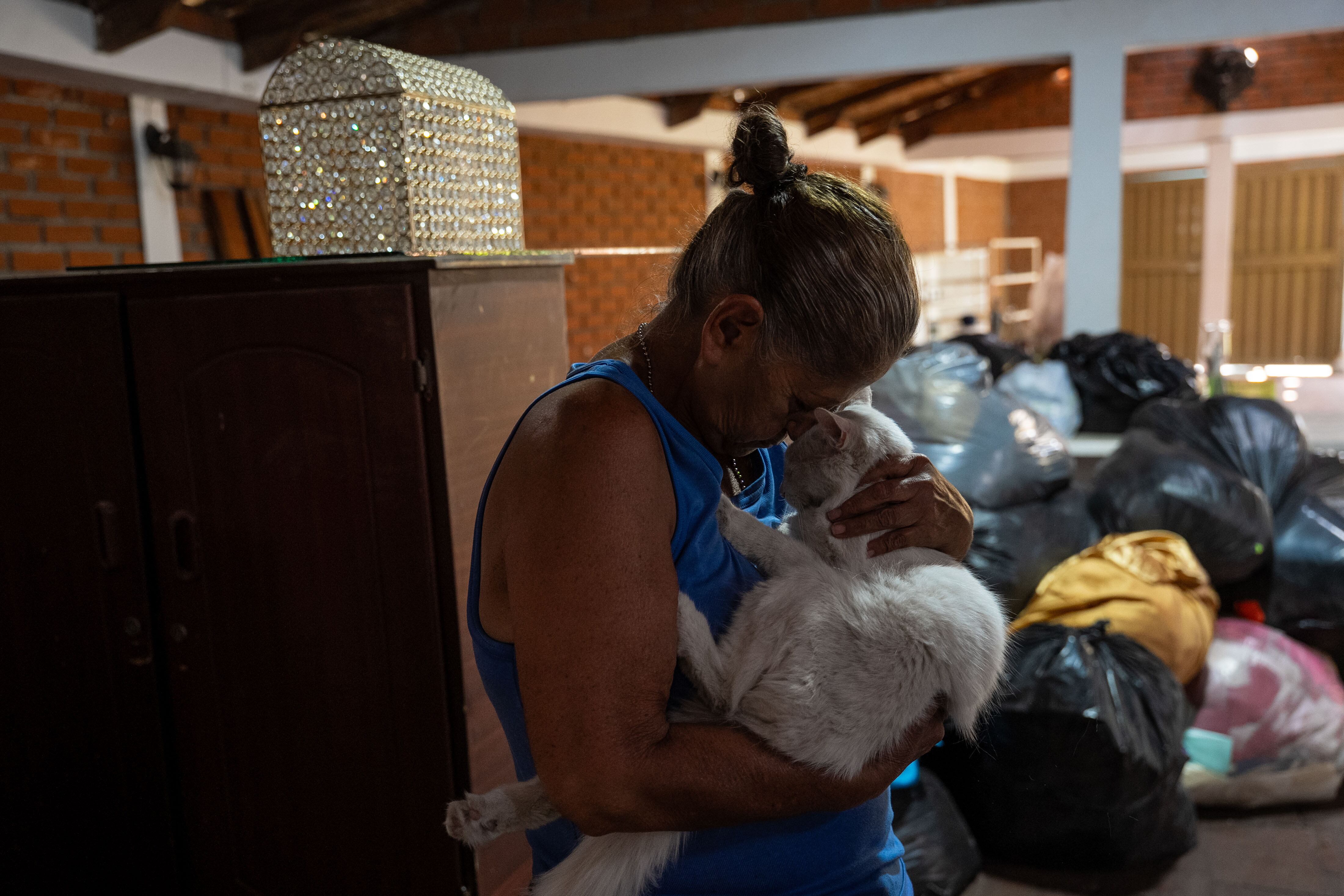 Lucía Moreno abraza a su gato en su casa afectada por el terremoto en Sevilla, Valle del Cauca, Colombia, el 14 de agosto.