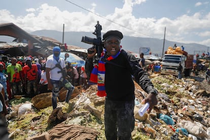 Barbecue, el líder de la pandilla "G9 and family", se para junto a la basura para llamar la atención sobre las condiciones en las que vive la gente mientras lidera una marcha contra el secuestro en el barrio La Saline en Puerto Príncipe.