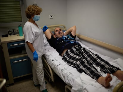 Un hombre se prepara para pasar la noche con un estudio de poligrafía cardiorespiratoria en una de las habitaciones destinadas al estudio del sueño en la Unidad de Sueño del Hospital Universitario Virgen de las Nieves de Granada.