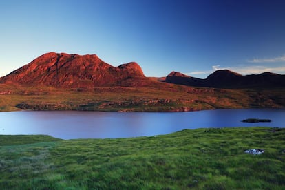 Los 111 kilómetros que separan Durness y Ullapool son quizá los más espectaculares de Escocia. Primero se atraviesa un ancho valle cubierto por un manto de brezos que se convierte después en un rocoso paisaje de gneis, salpicado por cientos de lochans (lagunas). Esta zona da paso a unas colinas cubiertas de tojos que constituyen la ante­sala a los imponentes montes de arenisca de Assynt y Coigach (en la foto). A esta zona se la denomi­na Northwest Highlands Geopark.