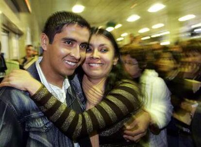 Un boliviano que ha pasado el control de pasaportes se abraza a su novia, que le esperaba en el aeropuerto de Barajas