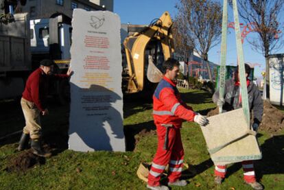 Unos operarios instalan el monumento en la avenida de Navarra.