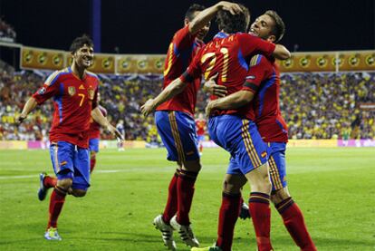 David Silva celebrates his first goal of the match with teammates.