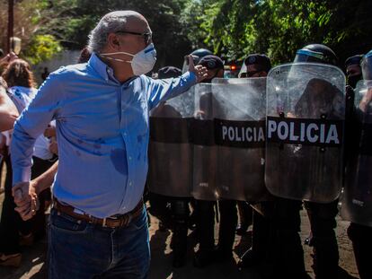 El periodista Carlos Fernando Chamorro, director de 'Confidencial', le reclama a la policía frente a las oficinas de su revista en Managua, el 14 de diciembre de 2020.