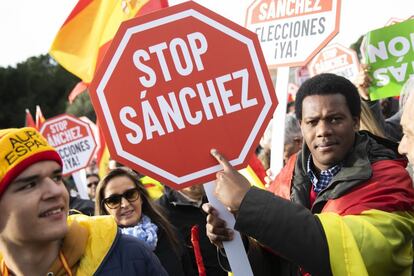 “We are gathered here today to tell the Spanish government that we are not willing to tolerate any more betrayal, or concessions to those who want to destroy our country,” said the manifesto, which was read by three journalists. In this photo, protesters holds signs with messages against the prime minister.