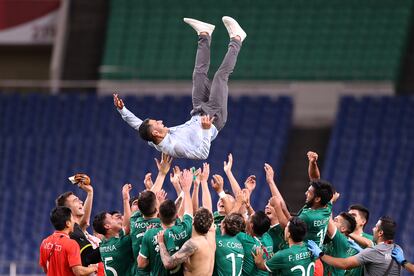 Jaime Lozano es lanzado al aire por los jugadores que ganaron la medalla de bronce en los Juegos Olímpicos de Tokio.