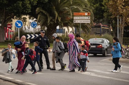 Una mujer musulmana cruza la calle con varios escolares en la barriada de Las Norias (El Ejido).