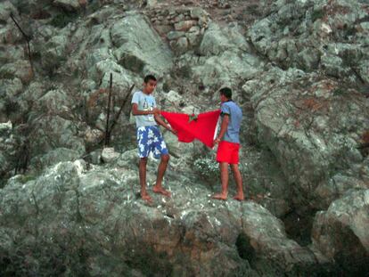 Dos activistas, a punto de desplegar la bandera de Marruecos en el Peñón de Vélez.