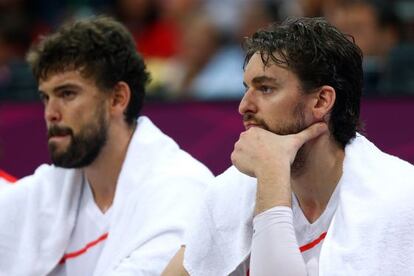 Marc Gasol (left) and Pau Gasol watch Spain&#039;s capitulation from the bench in London. 
