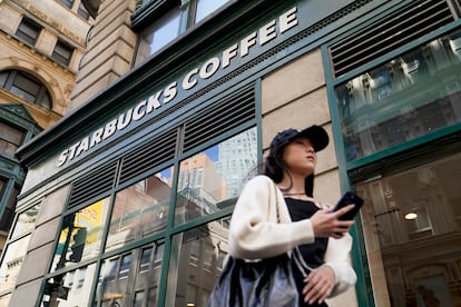 Pedestrians pass a Starbucks in the Financial District of Lower Manhattan