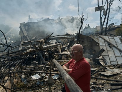 A man watches as emergency service personnel work at the site of a destroyed building after a Russian attack in Odesa, Ukraine, Thursday, July 20, 2023. Russia pounded Ukraine’s southern cities, including the port city of Odesa, with drones and missiles for a third consecutive night in a wave of strikes that has destroyed some of the country’s critical grain export infrastructure. (AP Photo/Libkos)