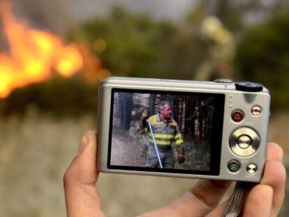 Un compa&ntilde;ero de Higinio Vivas L&oacute;pez muestra una imagen del brigadista fallecido en la extinci&oacute;n de un incendio en Castrelo do Val.