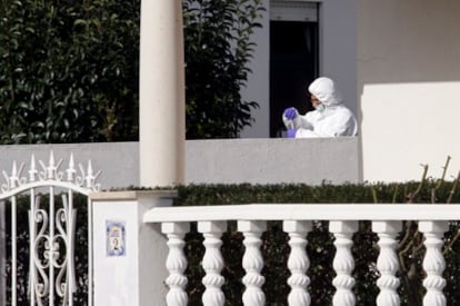 Un policía investiga la vivienda abandanoda por ETA en Obidos.