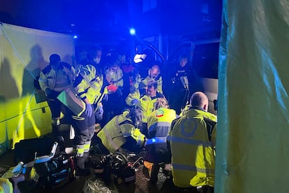 Miembros de Emergencias Madrid y de la Policia Nacional en la asistencia médica a la mujer tiroteada en Puente de Vallecas.