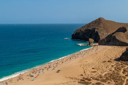 Top view of the beach on the shores of the Mediterranean Sea with its turquoise waters on a sunny summer day.