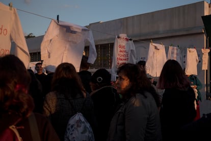 Shirts with names of missing people hang outside the stadium.