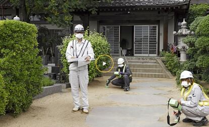 Fukushima council workers take radiation measurements.
