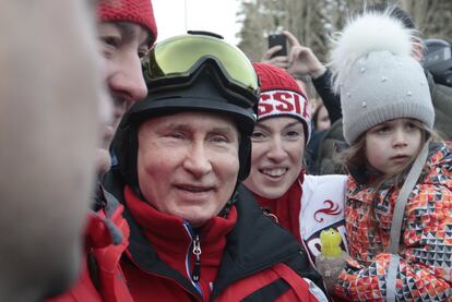 Aficionados al esquí se fotografían con Vladimir Putin, este miércoles, en la estación Gazprom Mountain Resort de Sochi (Rusia).