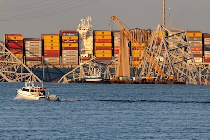 A large crane is positioned beside the cargo vessel 'Dali'  seen with toppled sections of the Francis Scott Key Bridge, in Baltimore, Maryland, March 29, 2024.
