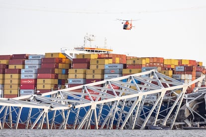 A helicopter flies over the container ship 'Dali' after the accident, Tuesday in Baltimore. 