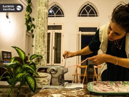 A member of the EatWith website prepares food for guests.