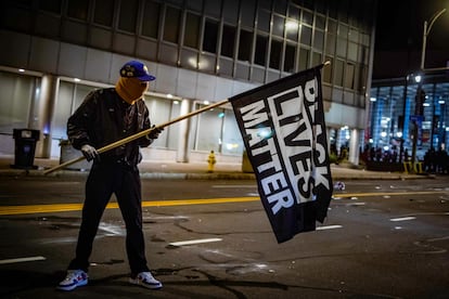 Manifestante com uma bandeira do movimento Black Lives Matter em Rochester, Estado de Nova York.