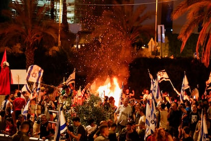 People demonstrate near a fire on the 'Day of National Resistance' in protest against Israeli Prime Minister Benjamin Netanyahu