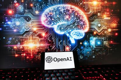 The OpenAI logo is displayed on a cell phone with an image on a computer monitor generated by ChatGPT's Dall-E text-to-image model, Friday, Dec. 8, 2023