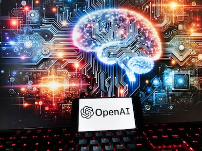 The OpenAI logo is displayed on a cell phone with an image on a computer monitor generated by ChatGPT's Dall-E text-to-image model, Friday, Dec. 8, 2023