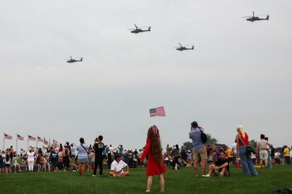 Parade assistants observe the passage of several helicopters.