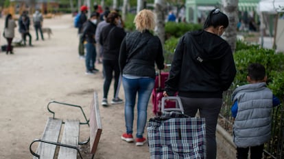 Cola para un reparto de alimentos en Aluche (Madrid), en abril de 2021.