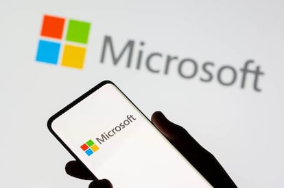 FILE PHOTO: A smartphone is seen in front of a Microsoft logo displayed in this illustration