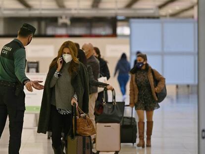 Un Guardia Civil vigila la entrada de pasajeros en Madrid-Barajas, donde se exige la prueba PCR negativa a las personas procedentes de países de riesgo.