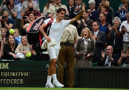 Federer saluda al público tras derrotar a Djokovic en la semifinal de Wimbledon.