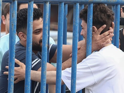 Syrian survivor Fedi, 18, right, one of 104 people who were rescued from the Aegean Sea after their fishing boat crammed with migrants sank, reacts as he reunites with his brother Mohammad, who came from Italy to meet him, at the port of Kalamata, Greece, Friday, June 16, 2023.
