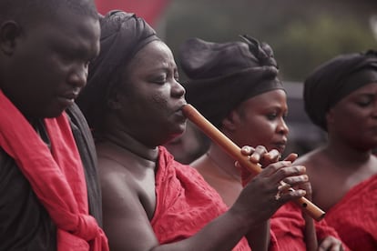 A musician plays her flute during the national service for victim's of a gas station that ignited last week in Accra, Ghana, Wednesday, June 10, 2015. The flooding in the capital last week caused fuel from a gas station to ignite, killing at least 160 people. As the country mourned the victims at a national service Wednesday, the Ghanaian government is facing allegations that poorly managed city planning contributed to the tragedy. (AP Photo/Christian Thompson)