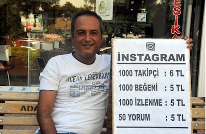 Yilmaz Fikriderin, junto al cartel que anuncia sus servicios.
