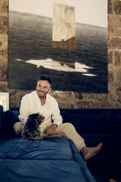 Fernando Tejero con su perrita 'Cata', en el salón de su casa, en El Escorial.