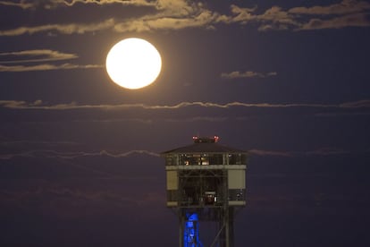 La superlluna darrere de la torre del telefèric del port de Barcelona.