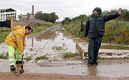 Un operario trataba ayer de acondicionar la vía férrea a su paso por Alcolea del Río (Sevilla).