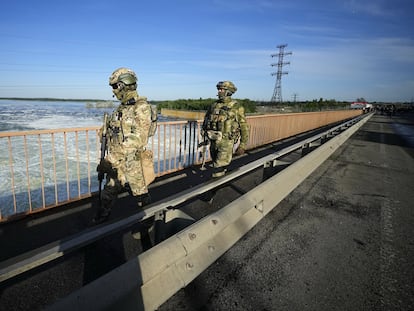 FILE - Russian troops patrol an area at the Kakhovka Hydroelectric Station, a run-of-river power plant on the Dnieper River in Kherson region, south Ukraine, on May 20, 2022. Moscow has warned that Ukraine may try to attack the dam at the Kakhovka hydroelectric power plant about 50 kilometers (30 miles) upstream and flood broad areas, including the city of Kherson. Ukrainian forces pressing an offensive in the south have zeroed in on Kherson, a provincial capital that has been under Russian control since the early days of the invasion. This photo was taken during a trip organized by the Russian Ministry of Defense. (AP Photo, File)