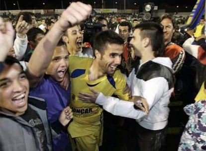 Los aficionados del Alcorcón celebran con sus jugadores, en el césped del Santo Domingo, la goleada al Real Madrid.
