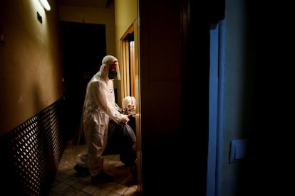 A volunteer from the non-profit Pro-Activa Open Arms taking a woman from a Barcelona care home to a city hospital. 