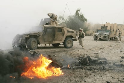 US soldiers next to an exploded car bomb in Abu Ghraib, April 3, 2005.