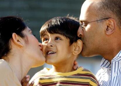 El pequeño Zain Hashmi recibe besos de sus padres tras ganar ayer una larga batalla judicial.