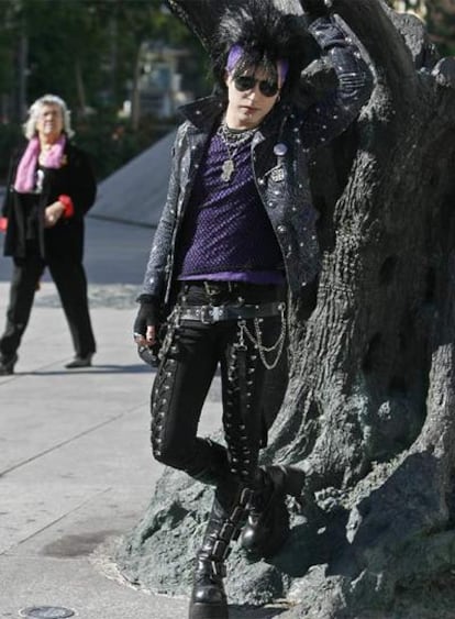 Un joven gótico, junto a una escultura de la plaza de Felipe II.