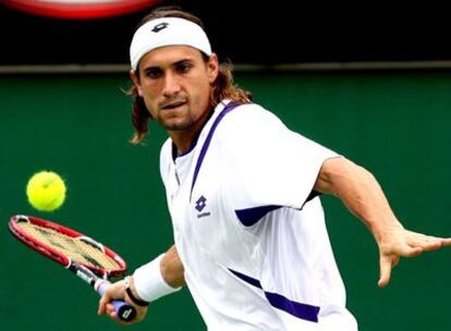 El tenista español David Ferrer devuelve la pelota al sueco Thomas Johansson durante el partido .