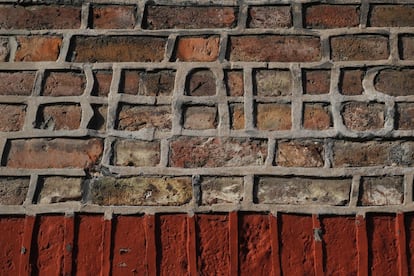 Detalle de una fachada de Madryin street. Alguien aprovechó una reparación para escribir Beatles con la masilla.